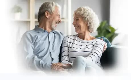 A happy, good-looking senior couple looking at each other and smiling